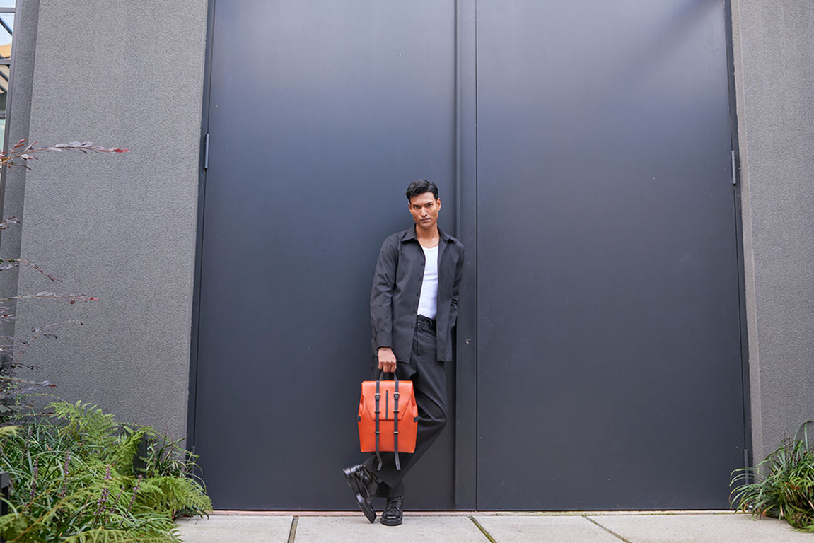 Sophisticated man displaying a PK1 Milano leather messenger bag