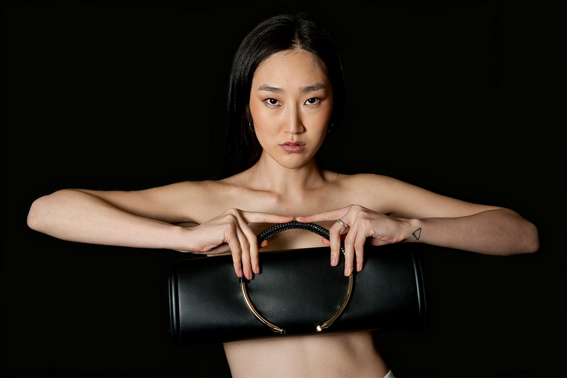 Model carrying a handcrafted luxury leather bag by PK1 Milano
