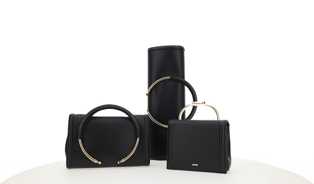 Collection of luxury leather handbags by PK1 Milano, highlighting the brand's commitment to sustainability and social responsibility