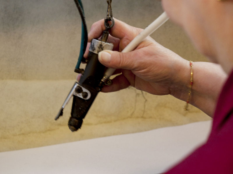 Artisan selecting high-quality leather materials at PK1 Milano