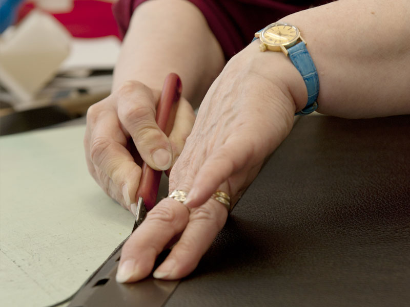 Artisan carefully crafting a luxury leather bag at PK1 Milano