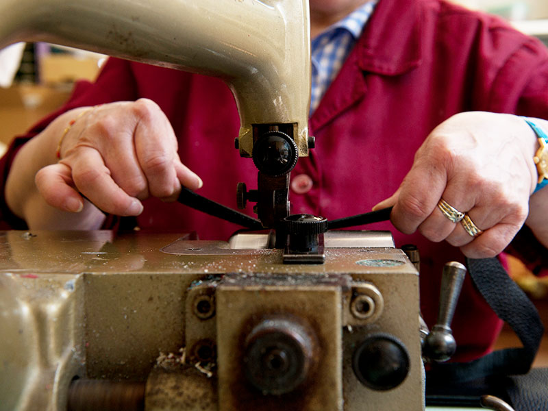 PK1 Milano artisan hand-finishing a bespoke leather accessory