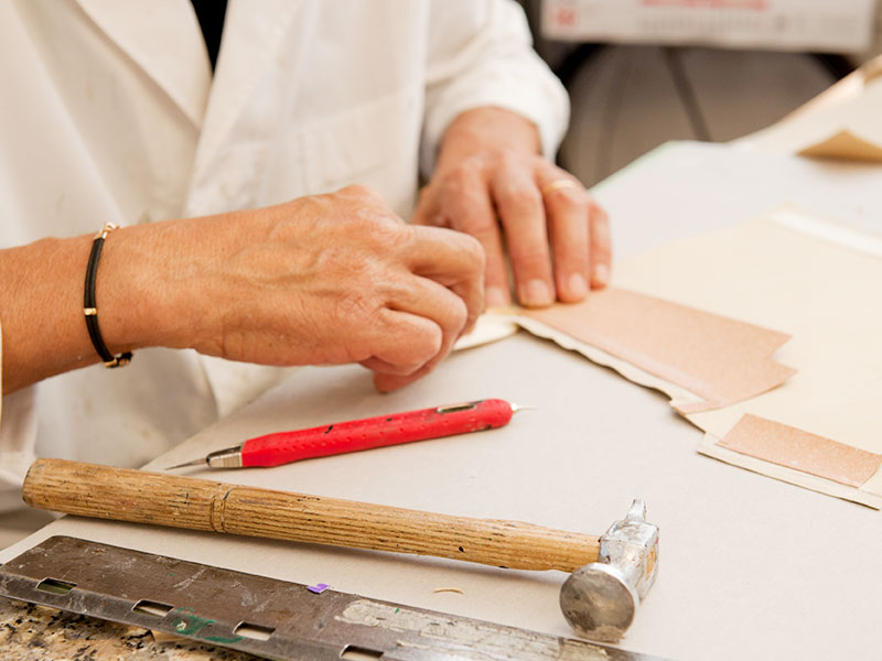 Detailed view of leather cutting tools at PK1 Milano workshop